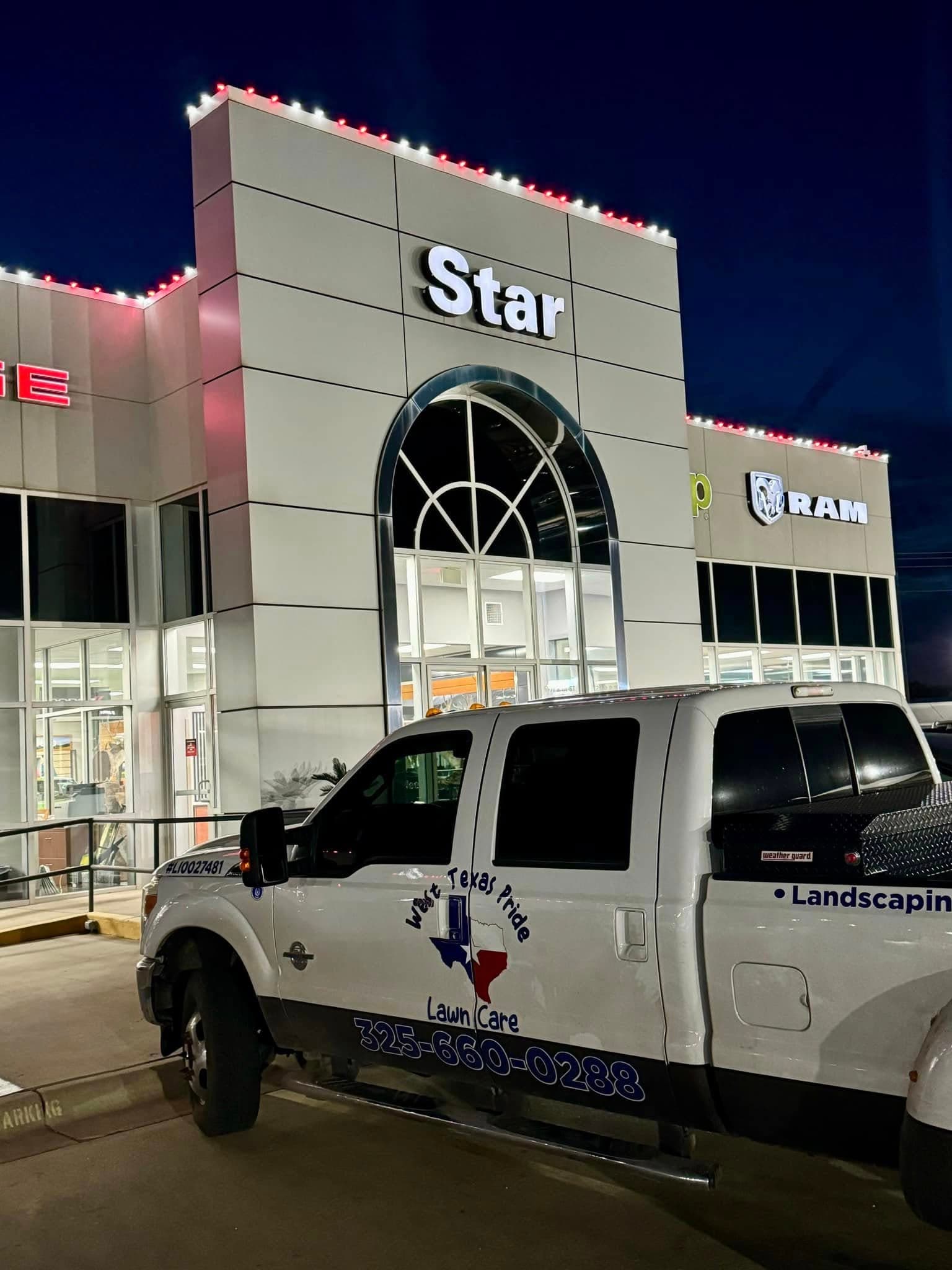 West Texas Pride branded truck at a commercial holiday-lighting project
